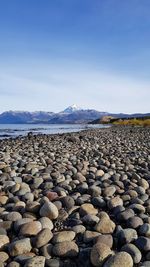 Surface level of stones on land against sky