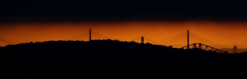 Silhouette of suspension bridge during sunset