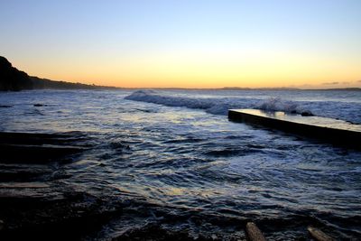 Scenic view of sea against clear sky during sunset