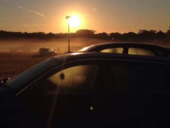 Cars on road at sunset