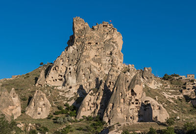 Low angle view of rock formations against blue sky