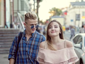 Portrait of woman with friend standing outdoors