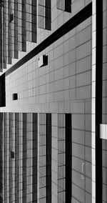 Low angle view of glass building against sky