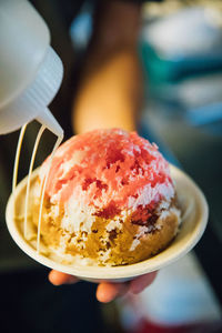 Close-up of hand holding ice cream