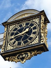 Low angle view of clock tower against sky