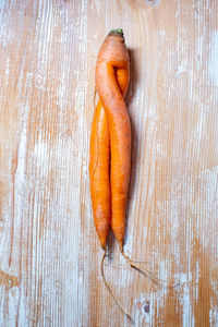 Unusual carrot on wooden surface