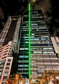 Low angle view of illuminated building against sky