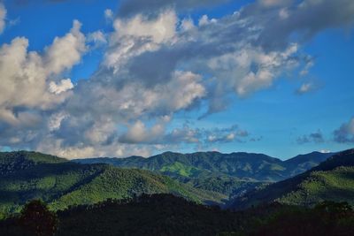 Countryside landscape against cloudy sky