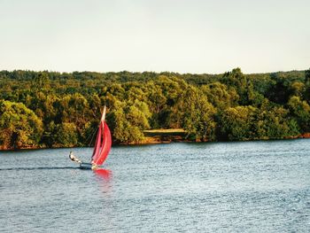 Man on boat in sea against sky