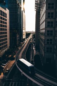 High angle view of monorail amidst buildings in city