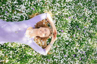 Portrait of happy woman lying on grass