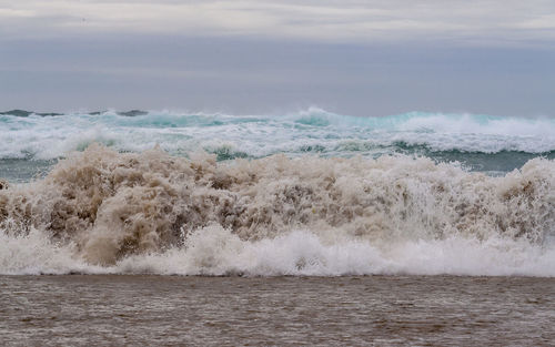 Waves breaking against sea