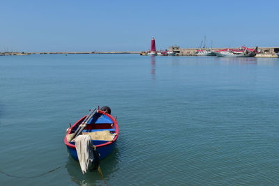 Boat sailing in sea against clear sky