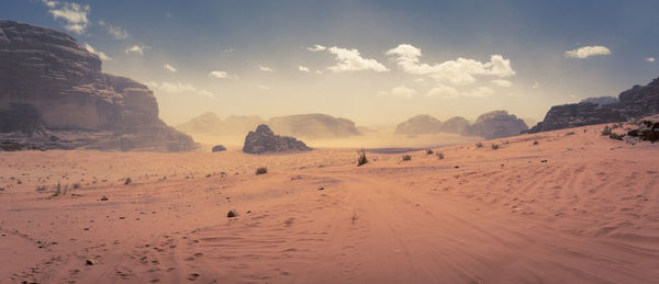 Desert scene at wadi rum, jordan, light sand storm in the distance