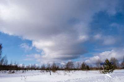 Scenic view of snow covered field against sky