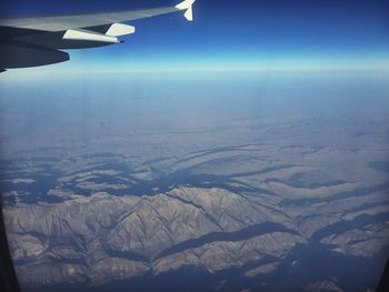 Cropped image of airplane flying over landscape