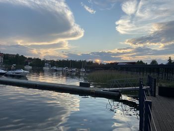 Boats moored at marina against sky during sunset