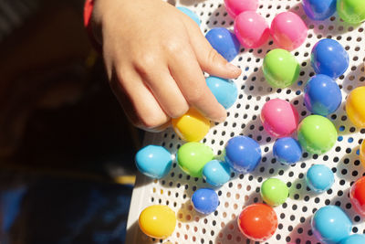 Cropped hand of woman with balloons