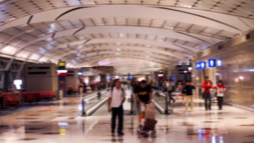 People walking on railroad station platform