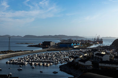 High angle view of harbor and buildings in city