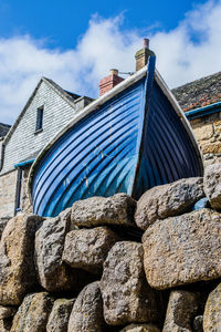 Low angle view of roof and building against sky