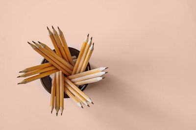 High angle view of pencils on yellow background
