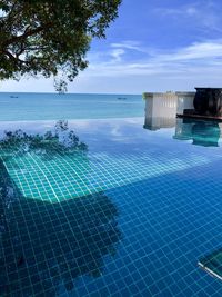 Scenic view of swimming pool by sea against sky