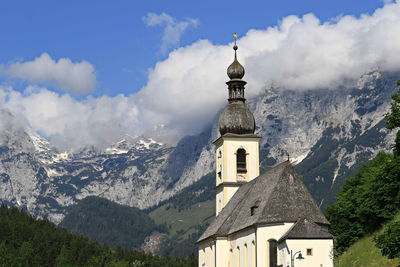 Low angle view of building and mountains against sky