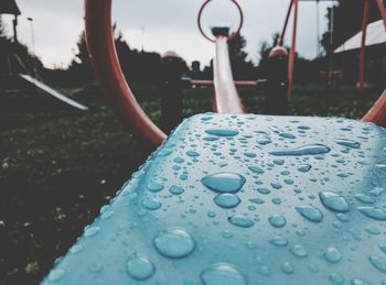 Close-up of wet umbrella against sky