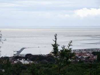 High angle view of townscape by sea against sky