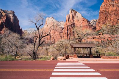 Zebra crossing on road against mountains