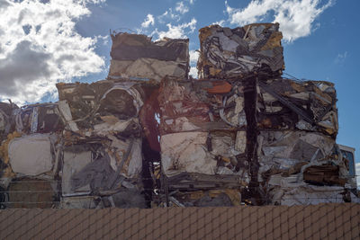 Low angle view of garbage against built structure