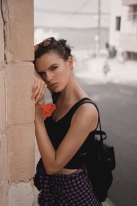 Beautiful woman standing against wall