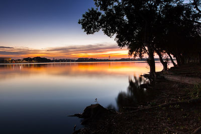 Scenic view of lake against sky during sunset