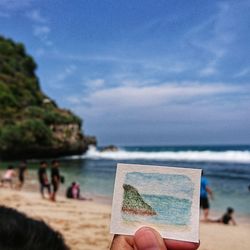 People on beach against sky