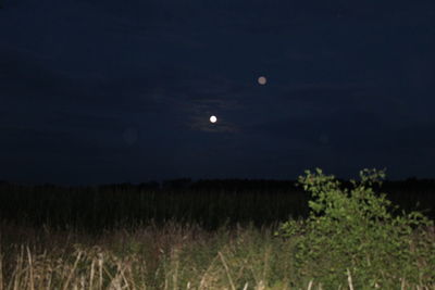 Scenic view of field against sky at night