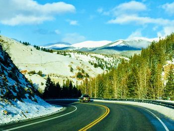 Road passing through mountains against sky