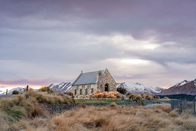 Sunrise view of the church of good shepherd with beautiful snow capped mountain range. 