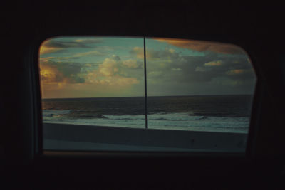 View of sea through window