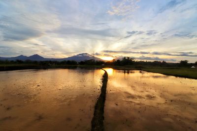 Scenic view of lake against sky during sunset