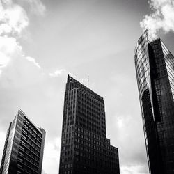 Low angle view of modern building against cloudy sky