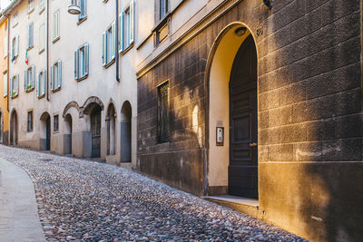 Empty alley amidst buildings in city