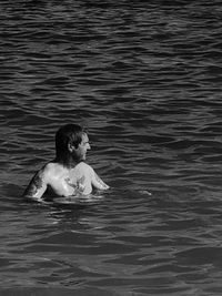Rear view of girl swimming in pool