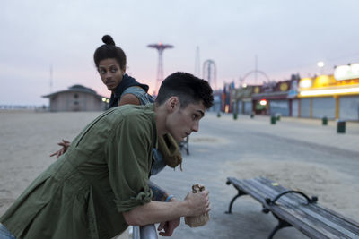 Friends hanging out at a boardwalk amusement park