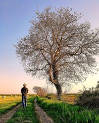 Man standing on field against sky