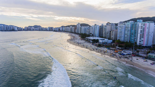 Panoramic view of city buildings by sea against sky