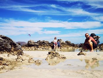 People on beach against sky