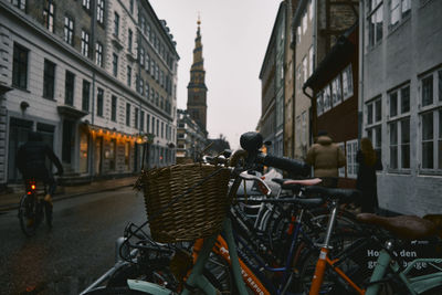 People on street amidst buildings in city