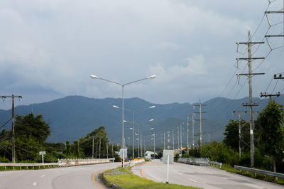 Street amidst mountains against sky