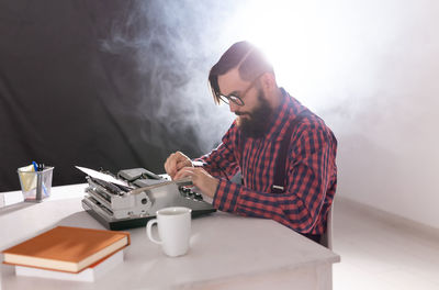 Man and coffee cup on table